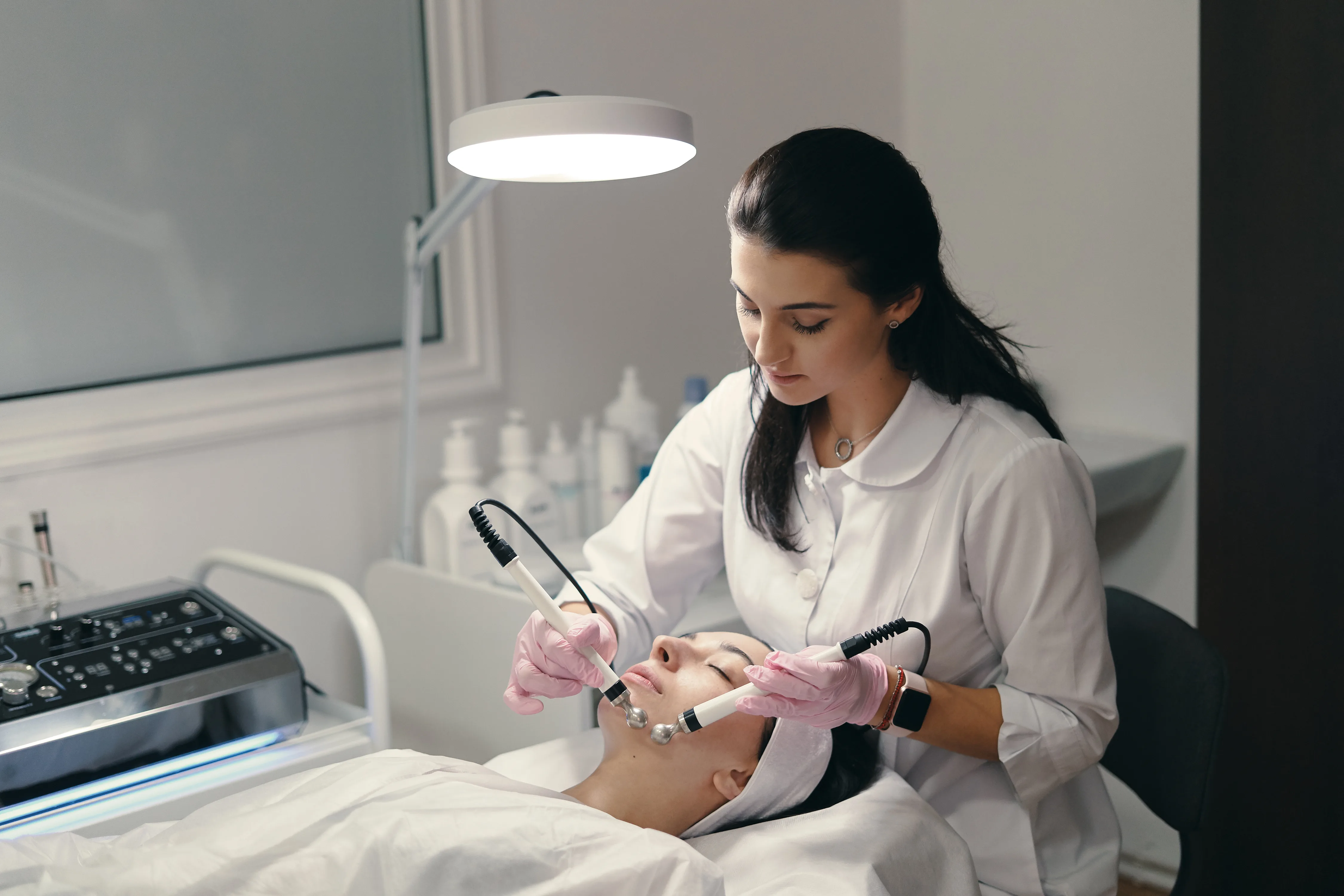 Skincare practitioner performing a facial treatment on a patient